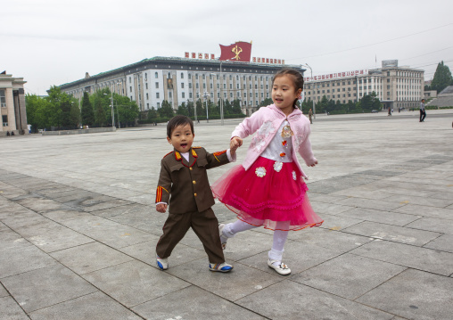 Boy dressed in soldier with his sister on Kim il Sung square, DGC, Pyongyang, North Korea