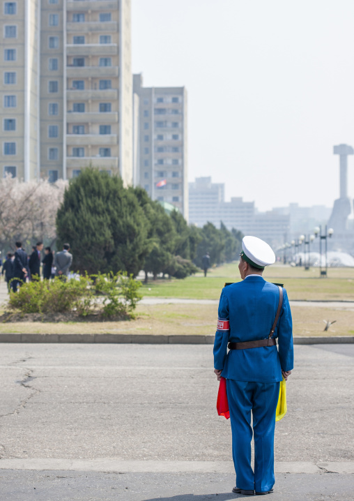 North Korean male traffic security officer in blue uniform in the street, DGC, Pyongyang, North Korea