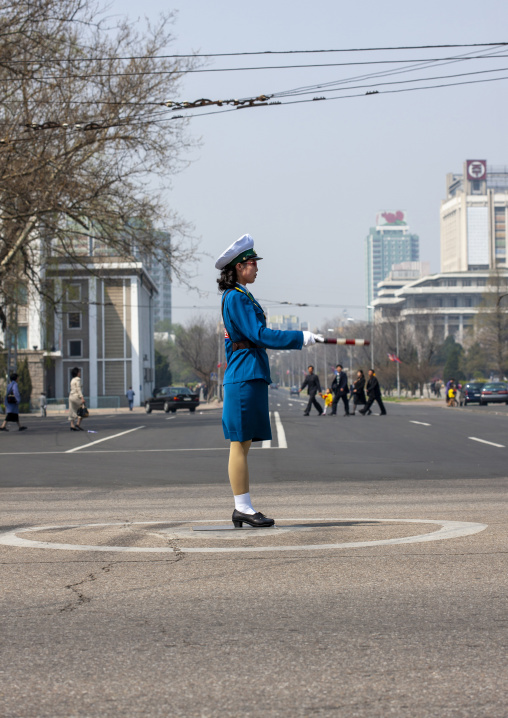 North Korean female traffic security officer in blue uniform in the street, DGC, Pyongyang, North Korea