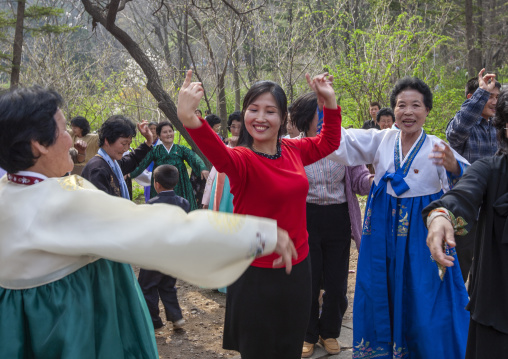 North Korean women dancing in a park for the day of the sun, DGC, Pyongyang, North Korea