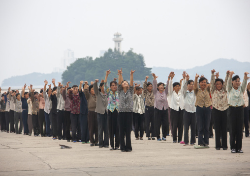 Women raising hands during morning exercise session, Kangwon Province, Wonsan, North Korea