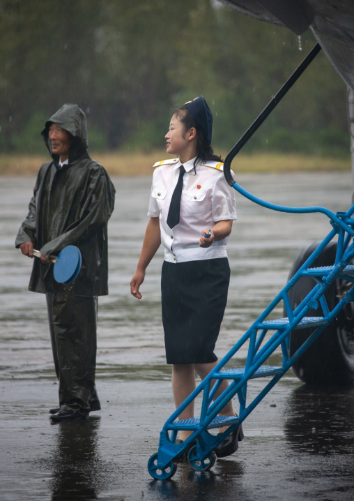 Airport employee before entering a domestic plane, South Hamgyong, Hamhung, North Korea