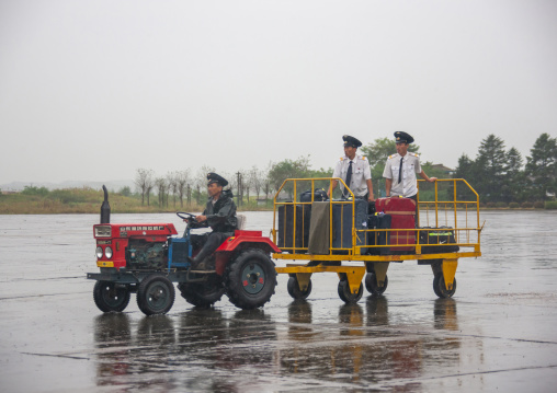 Tractor trailer and driver at Samjiyon airport picking up tourists luggages, Ryanggang, Samjiyon, North Korea