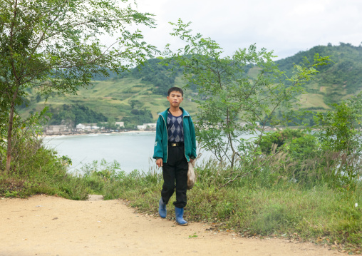 North Korean boy walking along the road, North Hamgyong, Jung Pyong Ri, North Korea