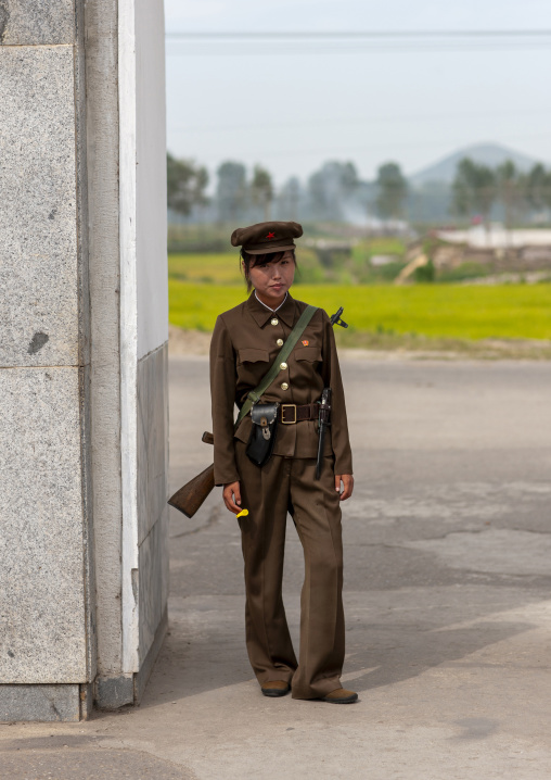 North Korean female solidier with rifle in Pyongyang film studio, DGC, Pyongyang, North Korea