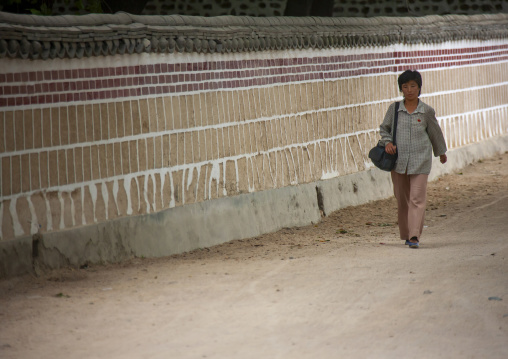 North Korean woman walking in the old town, North Hwanghae, Kaesong, North Korea