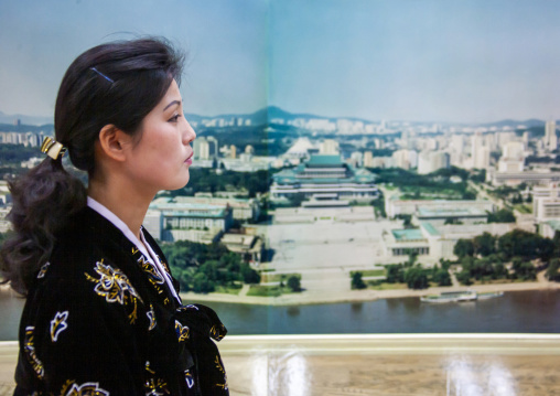 Portrait of a North Korean woman in front of Kil Il Sung square poster, DGC, Pyongyang, North Korea