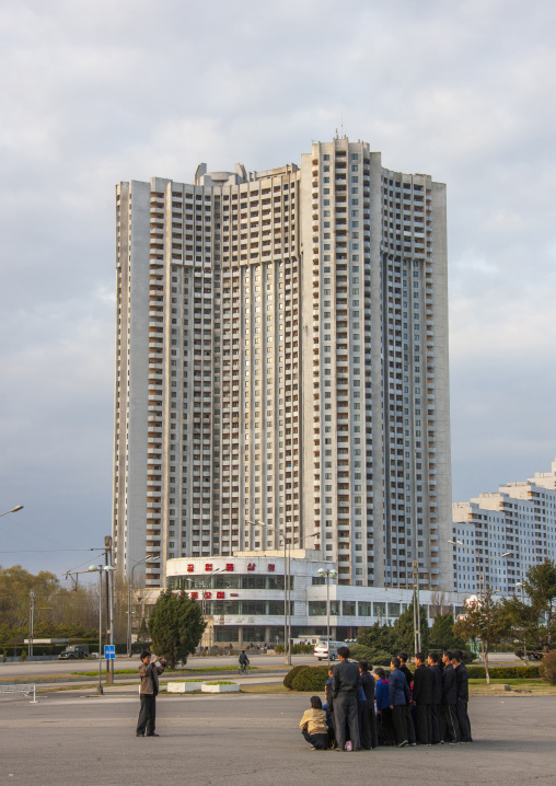 North Korean teacher taking a photo souvenir of students in town, DGC, Pyongyang, North Korea