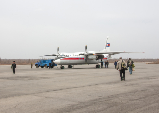 Tourists in front of an air Koryo North Korean plane for a domestic flight, Ryanggang, Samjiyon, North Korea