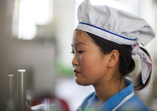 North Korean worker woman in kangso yaksu mineral water factory, South Pyongan, Nampo, North Korea