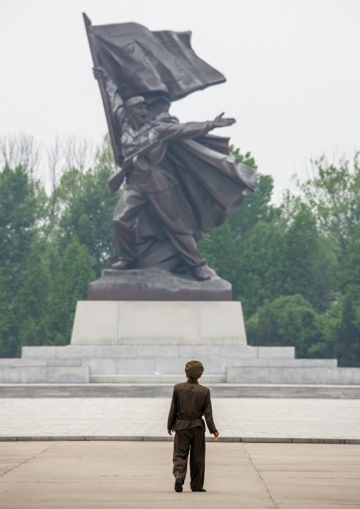 North Korean man standing in front of a soldier statue, DGC, Pyongyang, North Korea