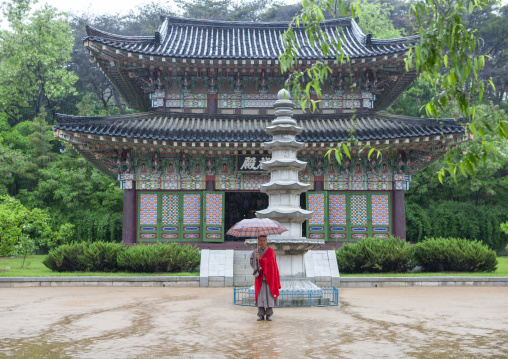 Monk under the rain in Kwangbok temple, DGC, Pyongyang, North Korea