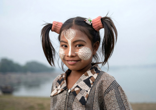 Portrait of a burmese girl with thaaka on the face, Amarapura, Mandalay, Myanmar