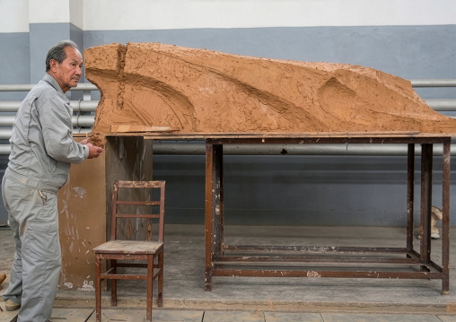 Artist working on a bronze statue at Mansudae art studio, DGC, Pyongyang, North Korea