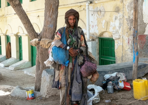 Sufi man carrying bags to travel, Sahil region, Berbera, Somaliland
