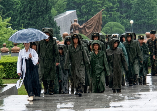 Soldiers under the rain in Taesongsan revolutionary martyr cemetery, DGC, Pyongyang, North Korea