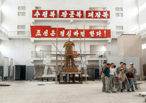 Artists working on a bronze statue at Mansudae art studio, DGC, Pyongyang, North Korea