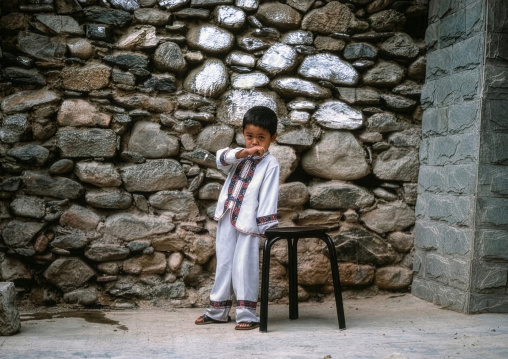 Naxi boy in traditional clothing, Lijiang, Yunnan Province, China