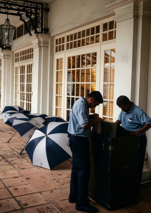 Eastern And Oriental Hotel entrance with umbrellas, Penang island, George Town, Malaysia