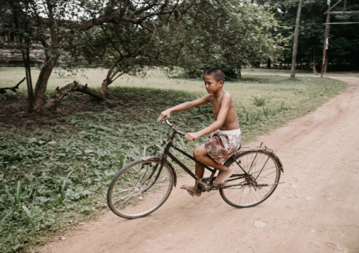 Cambodian boy riding a bicycle, Phnom Penh province, Phnom Penh, Cambodia