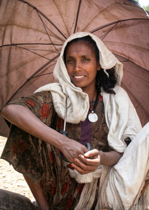 Ethiopian woman under an umbrella, Amhara Region, Lalibela, Ethiopia