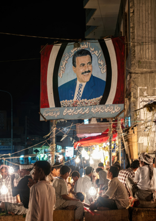 Ali Abdullah Saleh poster above night khat market, Al Hudaydah Governorate, Hodeidah, Yemen