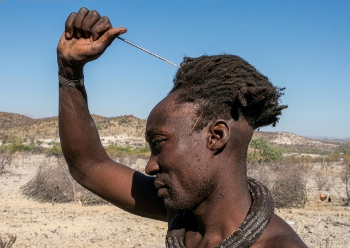 Himba tribe man with a comb, Cunene Province, Oncocua, Angola