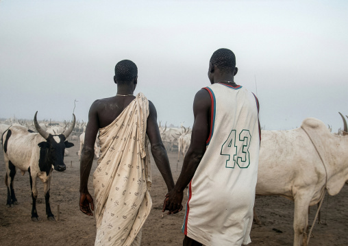 Mundari tribe men walking hand in hand, Central Equatoria, Terekeka, South Sudan
