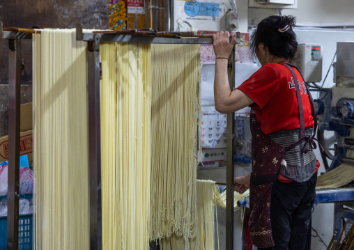 Taiwanese people hanging rice noodles in a shop, New Taipei, Tamsui, Taiwan