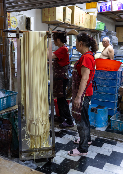 Taiwanese people hanging rice noodles in a shop, New Taipei, Tamsui, Taiwan