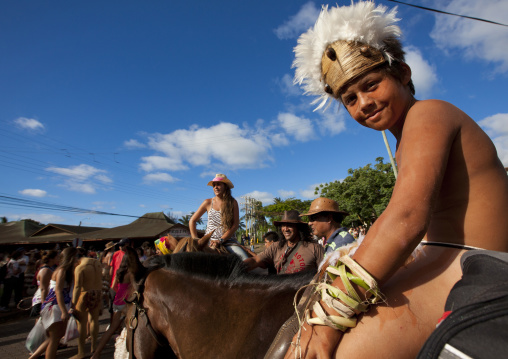 Kid on a horse during tapati festival, Easter Island, Hanga Roa, Chile