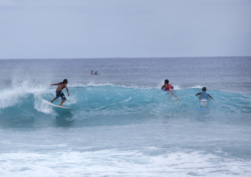 Surfers on waves, Easter Island, Hanga Roa, Chile