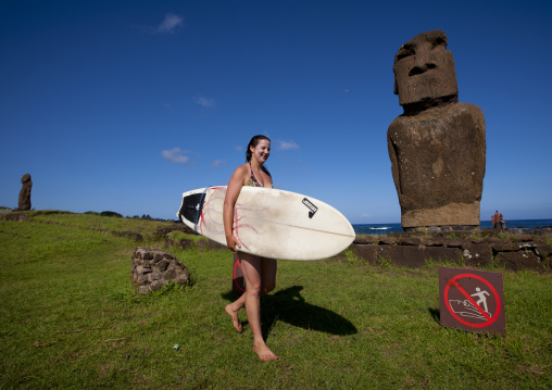 Surfer passing  in front of ahu tautira , Easter Island, Hanga Roa, Chile