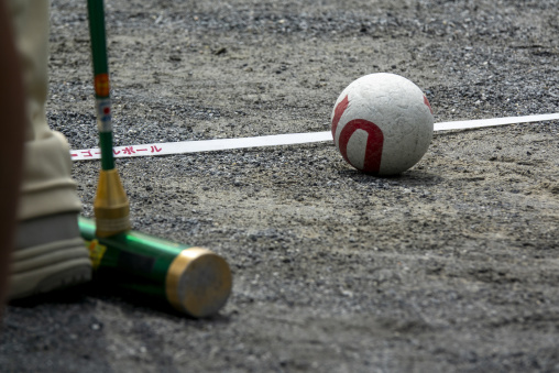 Close-up of a gateball mallet and ball on a gravel court, Kanto