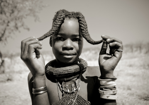 Himba Girl Called Kamundomba Holding Her Two Plaits, Village Of Habu Haru, Angola