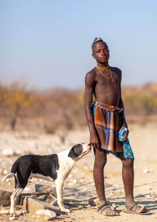 Himba tribe young man with a dog, Cunene Province, Oncocua, Angola