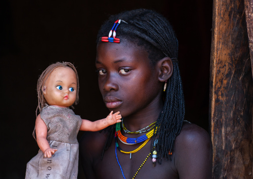 Muhacaona tribe girl with a western doll, Cunene Province, Oncocua, Angola