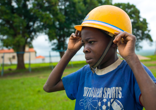 Angolan boy wearing a yellow safety helmet, Malanje Province, Calandula, Angola