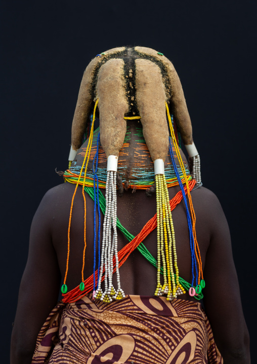 Rear view of a Mumuhuila tribe woman, Huila Province, Chibia, Angola