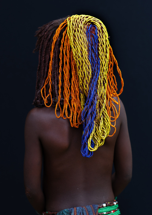 Rear view of a Mumuhuila tribe girl with a fico wig, Huila Province, Chibia, Angola