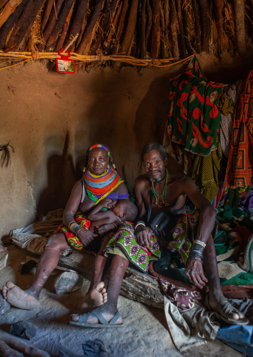 Mumuhuila tribe family inside their hut, Huila Province, Chibia, Angola