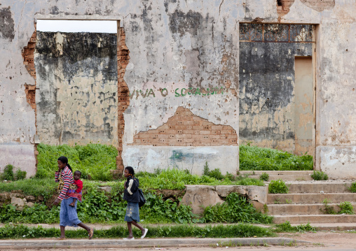 Girls Passing By A Building In Ruins, Vila Nova, Angola