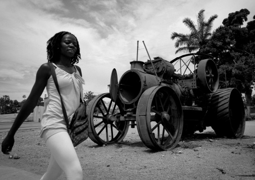 Young Woman In Front Of A Tractor Wreck In Lobito, Angola
