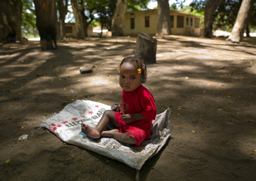 Young Girl Sitting On An Empty Sack, Village Of Dombe Grande, Angola