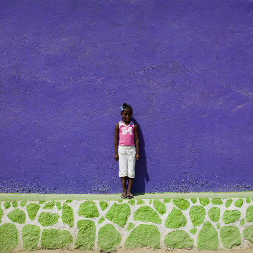 Girl In Front Of A Purple Wall In Namibe Town, Angola