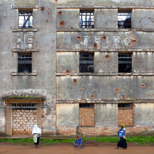 Women In Front Of The Facade Riddled Of Bullets Of Empreza Frabrica De Angola, Kuito,  Angola