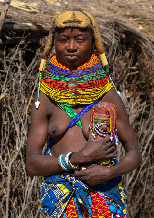 Mumuhuila tribe woman holding a traditional doll, Huila Province, Chibia, Angola
