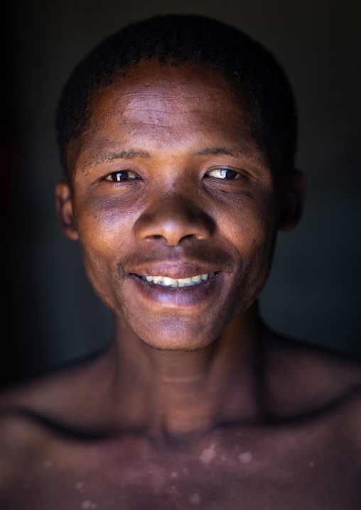 San tribe man smiling portrait, Huila Province, Chibia, Angola