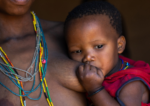 San tribe toddler breastfeeding, Huila Province, Chibia, Angola