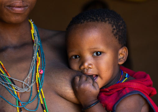 San tribe toddler breastfeeding, Huila Province, Chibia, Angola
